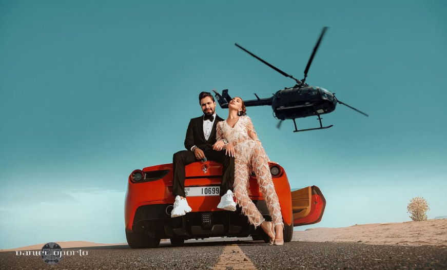 Campaña de Oporto con una pareja junto a un automóvil rojo y un helicóptero en el desierto